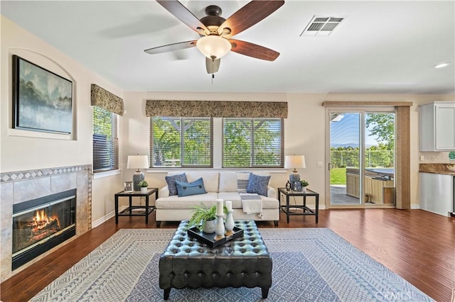 25302 Rolling Greens Way, Saugus, CA 91350 - living room featuring wood finished floors, ceiling fan, a tiled fireplace, and baseboards