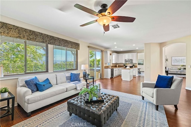 25302 Rolling Greens Way, Saugus, CA 91350 - living room with dark wood-style floors, ceiling fan, arched walkways, and recessed lighting