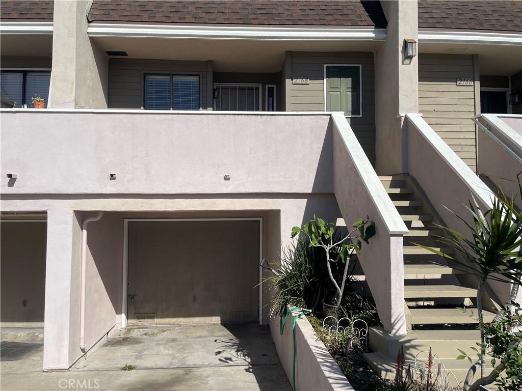 2168 Biscayne, Costa Mesa, CA 92627 - exterior space featuring an attached garage, stairway, driveway, and a shingled roof