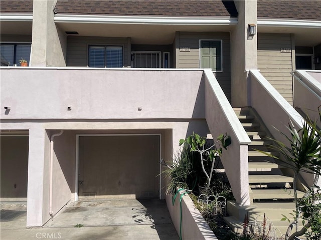 2168 Biscayne, Costa Mesa, CA 92627 - exterior space featuring an attached garage, stairway, driveway, and a shingled roof