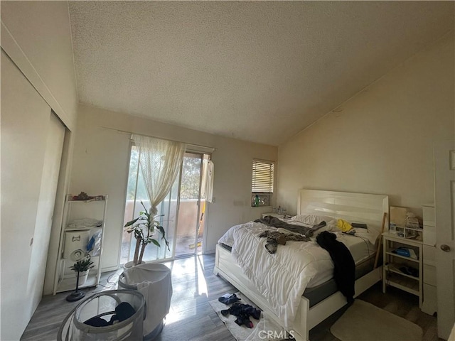 2168 Biscayne, Costa Mesa, CA 92627 - bedroom with lofted ceiling, wood finished floors, access to exterior, a closet, and a textured ceiling