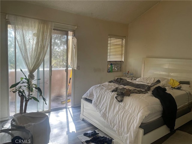 2168 Biscayne, Costa Mesa, CA 92627 - bedroom featuring vaulted ceiling, wood finished floors, and access to exterior