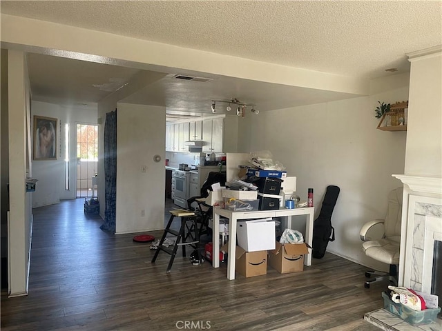 2168 Biscayne, Costa Mesa, CA 92627 - office space featuring a high end fireplace, rail lighting, visible vents, a textured ceiling, and dark wood-style flooring