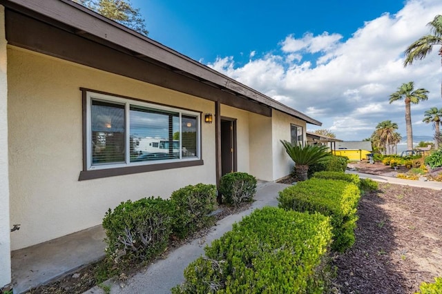 entrance to property with stucco siding