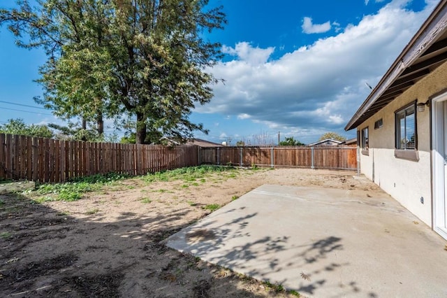 view of yard with a fenced backyard and a patio area