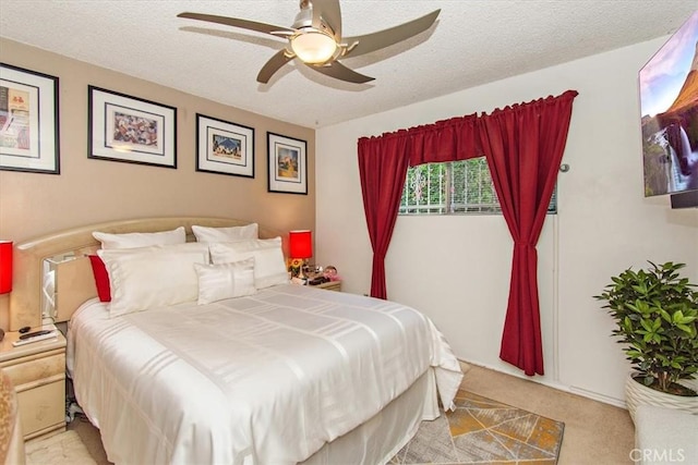 bedroom with carpet, a textured ceiling, and a ceiling fan