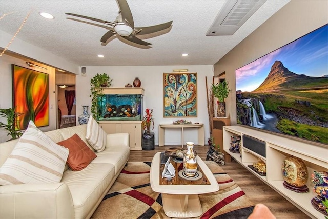 living room with ceiling fan, wood finished floors, and recessed lighting