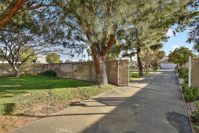 view of road featuring a gated entry and concrete driveway