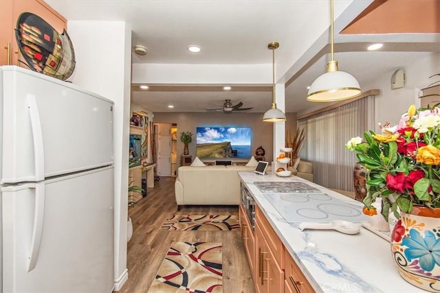 kitchen featuring recessed lighting, brown cabinets, white appliances, light wood-style flooring, and ceiling fan