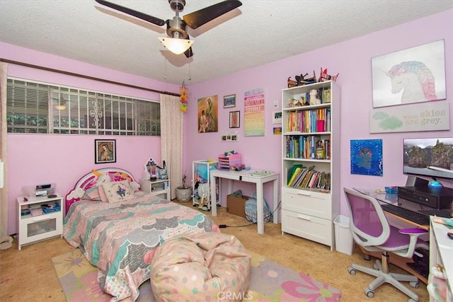 carpeted bedroom with a textured ceiling and ceiling fan