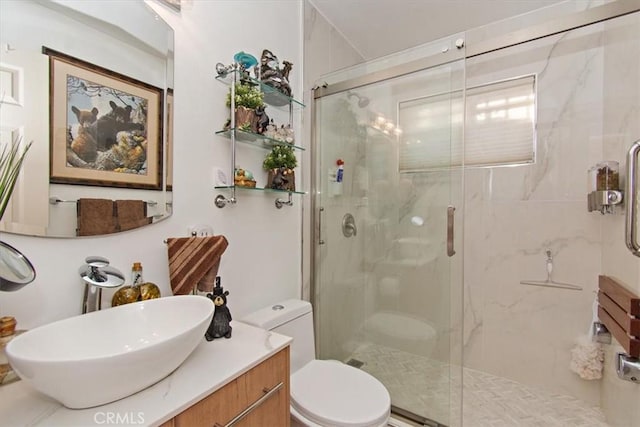 full bath featuring a shower stall, toilet, and vanity
