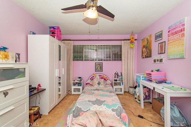 bedroom with ceiling fan, light carpet, and a textured ceiling
