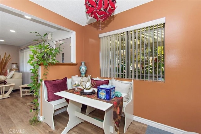 dining room with recessed lighting, wood finished floors, and baseboards
