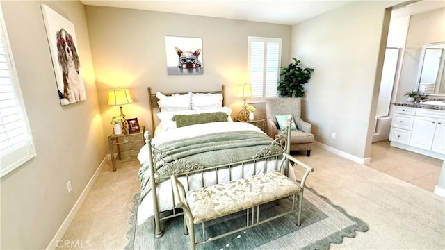 105 Tinker, Irvine, CA 92618 - bedroom with light carpet, baseboards, a sink, and ensuite bath