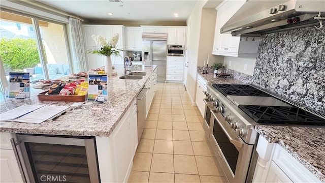 105 Tinker, Irvine, CA 92618 - kitchen featuring high quality appliances, wine cooler, under cabinet range hood, a sink, and light tile patterned floors