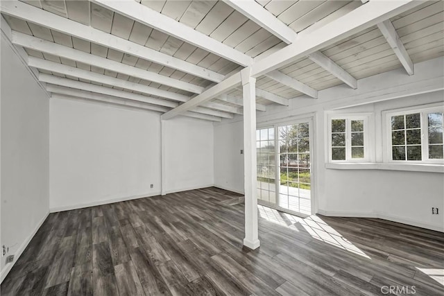 basement featuring baseboards, wood finished floors, and a healthy amount of sunlight