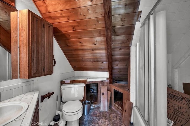bathroom featuring lofted ceiling, toilet, and vanity