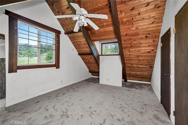 interior space with lofted ceiling, wooden ceiling, baseboards, carpet floors, and a ceiling fan