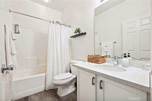 43475 Brahea Ct, Indio, CA 92201 - bathroom with toilet, wood finished floors, vanity, and shower / tub combo