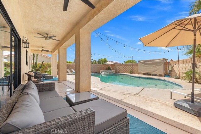 43475 Brahea Ct, Indio, CA 92201 - view of swimming pool with a ceiling fan, an outdoor living space, a fenced backyard, a patio, and a pool with connected hot tub