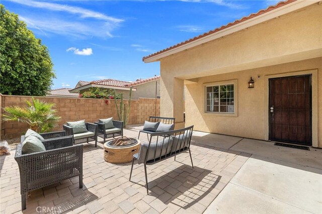 43475 Brahea Ct, Indio, CA 92201 - view of patio with an outdoor living space with a fire pit