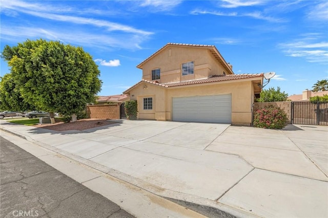 43475 Brahea Ct, Indio, CA 92201 - mediterranean / spanish-style house with stucco siding, concrete driveway, a tile roof, and a garage