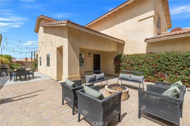 43475 Brahea Ct, Indio, CA 92201 - view of patio featuring an outdoor living space with a fire pit