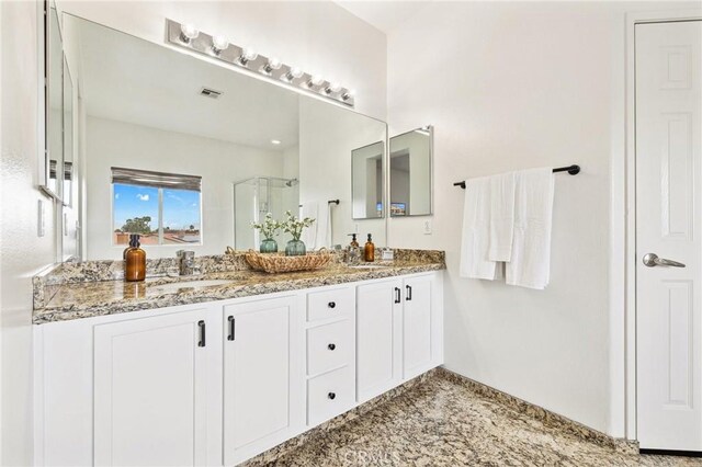 43475 Brahea Ct, Indio, CA 92201 - bathroom featuring a shower stall, double vanity, and baseboards
