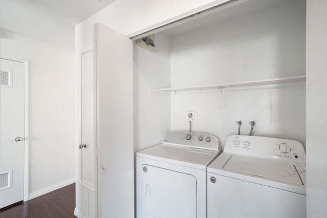 laundry room featuring laundry area, washer and clothes dryer, dark wood-style floors, and visible vents