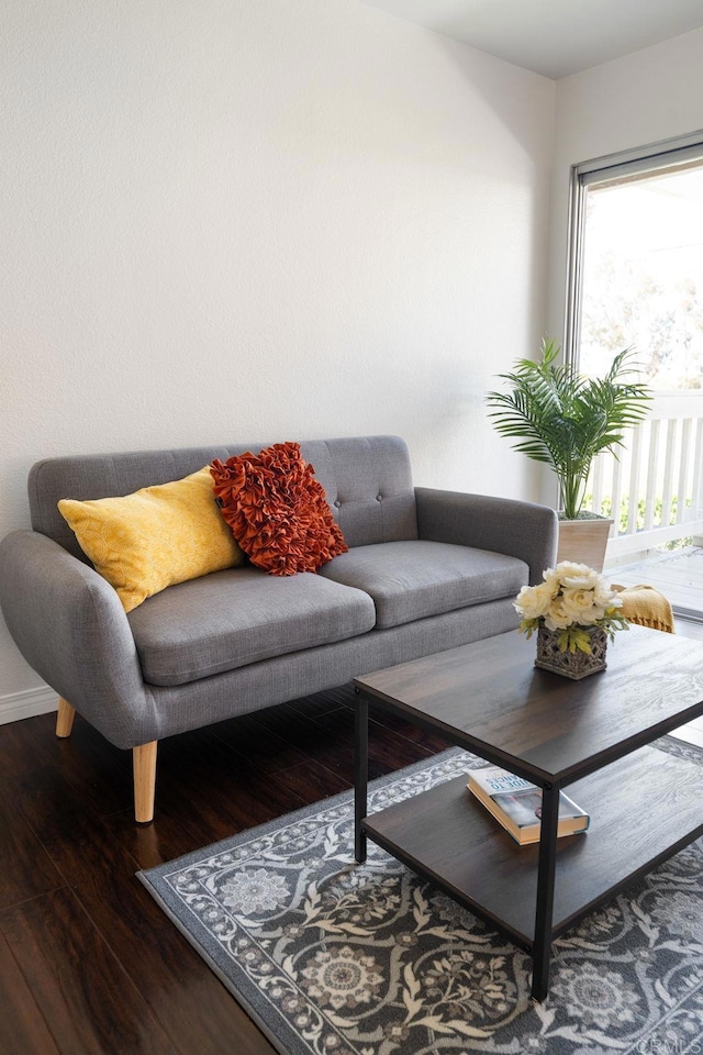 living room featuring baseboards and wood finished floors