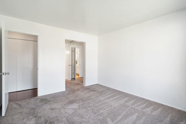 unfurnished bedroom featuring baseboards and carpet