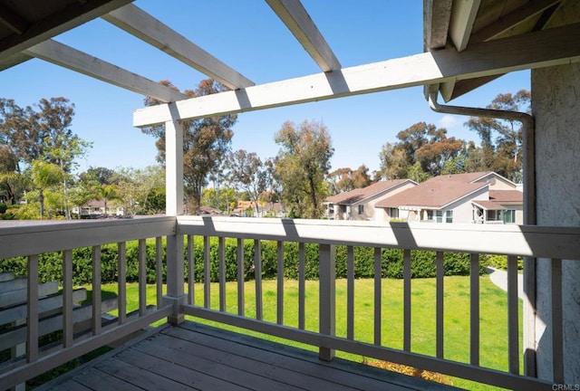 wooden deck featuring a lawn and a residential view