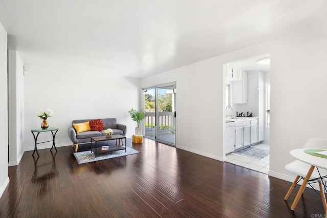 living area with wood finished floors and baseboards