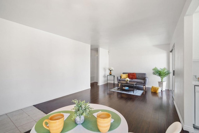 living room with baseboards and wood finished floors