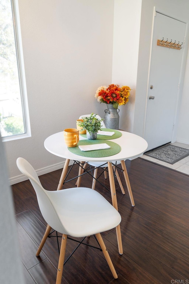 dining area featuring baseboards and wood finished floors