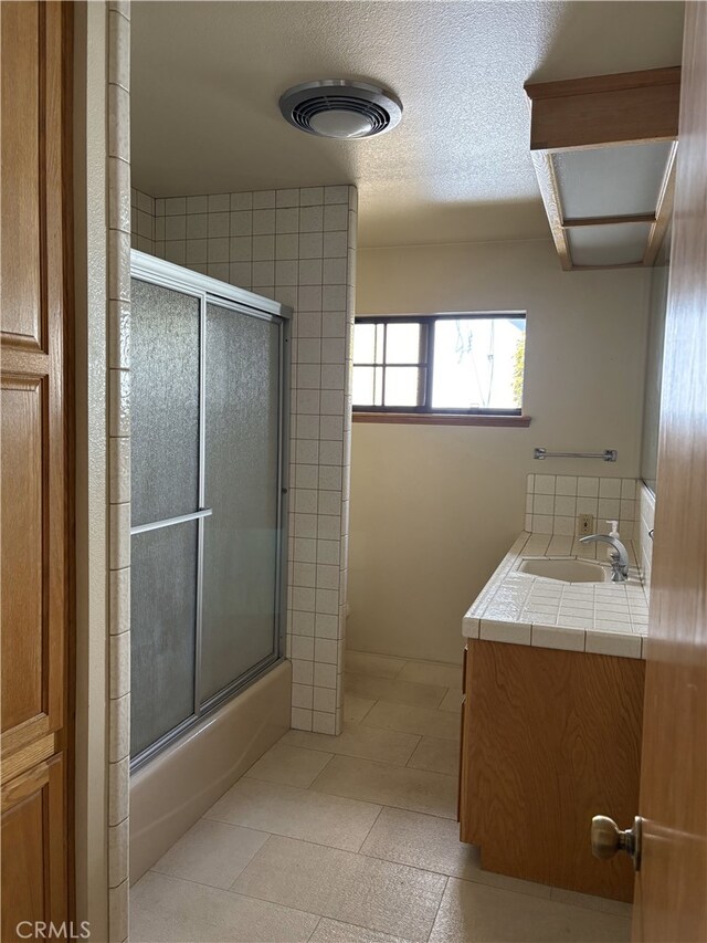 full bathroom with vanity, enclosed tub / shower combo, tile patterned floors, and visible vents
