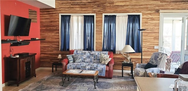 living room with tile patterned flooring and baseboards