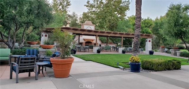 view of patio with an outdoor living space with a fireplace