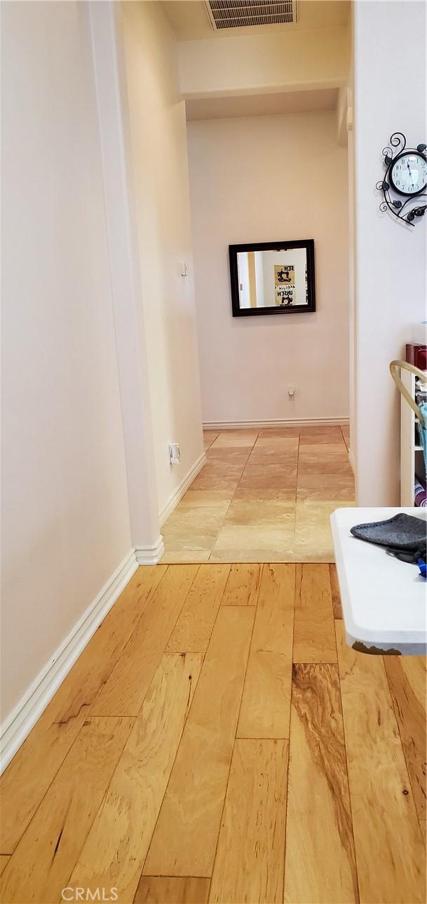 hall featuring visible vents and light wood-type flooring