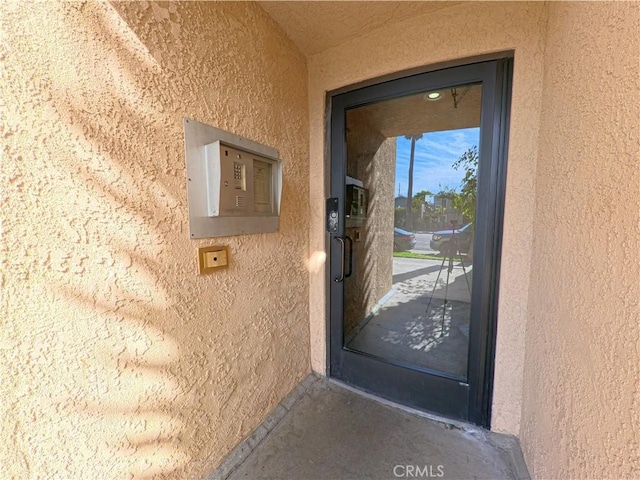 entrance to property with stucco siding