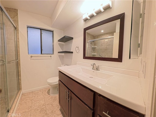 bathroom featuring baseboards, toilet, vanity, and a stall shower