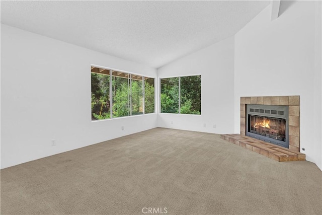 7650 Cristobal Ave, Atascadero, CA 93422 - unfurnished living room with carpet, vaulted ceiling, a fireplace, and a textured ceiling