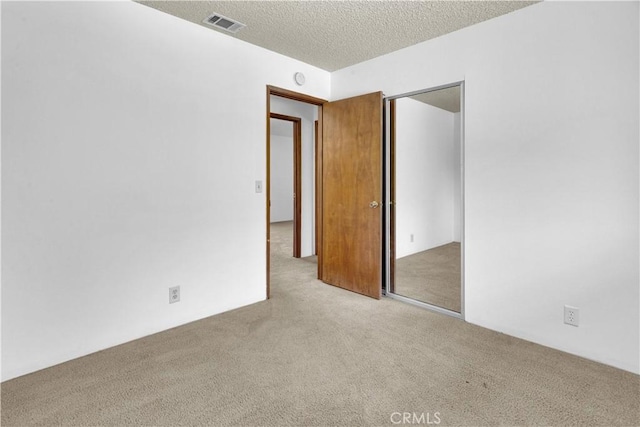 7650 Cristobal Ave, Atascadero, CA 93422 - unfurnished bedroom featuring carpet flooring, a closet, and a textured ceiling