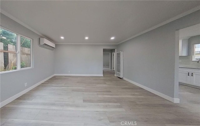 805 Earlham St, Pasadena, CA 91101 - empty room featuring a wall unit AC, ornamental molding, baseboards, and light wood finished floors