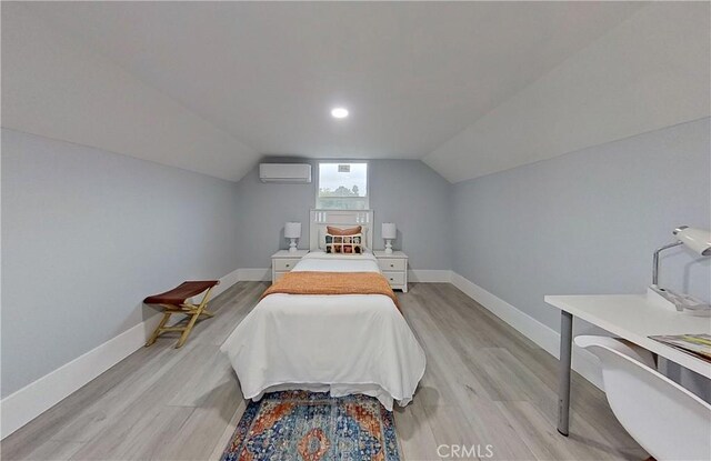 805 Earlham St, Pasadena, CA 91101 - bedroom with baseboards, a wall mounted AC, lofted ceiling, and light wood-style flooring