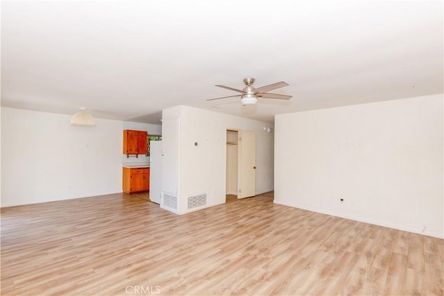 unfurnished living room featuring light wood-type flooring and a ceiling fan