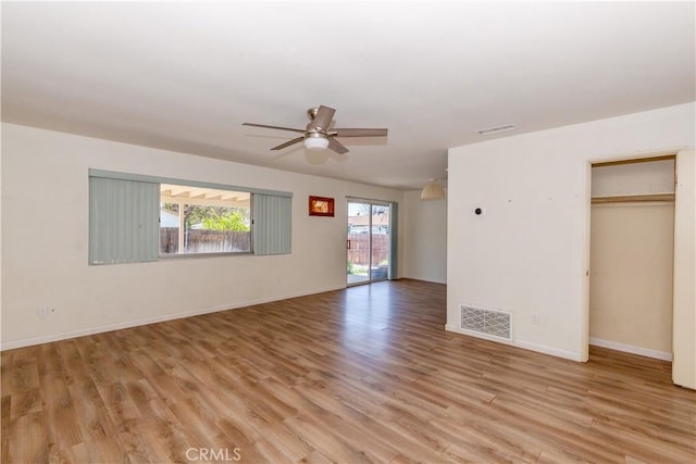 interior space featuring visible vents, baseboards, light wood finished floors, and ceiling fan
