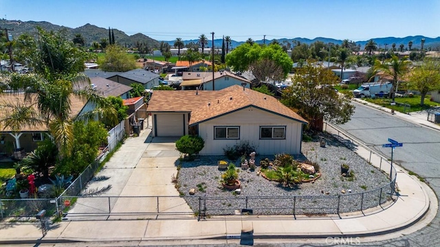 birds eye view of property with a mountain view and a residential view