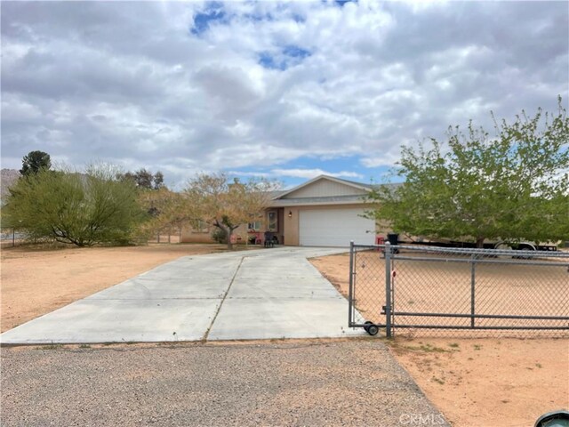 ranch-style house featuring a gate, driveway, fence, and a garage