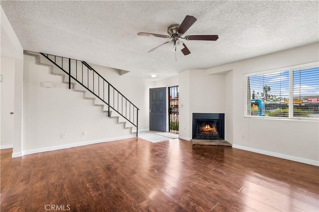 19231 Sherman Way Unit 44, Reseda, CA 91335 - unfurnished living room with baseboards, stairs, wood finished floors, and a ceiling fan